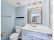 Light and airy bathroom with a wooden vanity, a large mirror, and ample lighting at 3468 51St Avenue W Dr, Bradenton, FL 34210