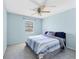 Cozy bedroom with a large bed, ceiling fan, and natural light from the window at 3468 51St Avenue W Dr, Bradenton, FL 34210