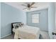 Bedroom offers a ceiling fan, a bed with a plush comforter, and a window for natural light at 3468 51St Avenue W Dr, Bradenton, FL 34210