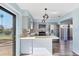 Bright kitchen with stainless steel appliances, light gray cabinetry, and a view of the landscaped backyard at 3468 51St Avenue W Dr, Bradenton, FL 34210