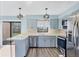Modern kitchen with stainless steel appliances, sleek countertops, and a view of the outdoor landscape at 3468 51St Avenue W Dr, Bradenton, FL 34210