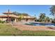 Community pool and clubhouse surrounded by well-manicured lawns and mature trees at 3468 51St Avenue W Dr, Bradenton, FL 34210
