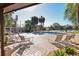 Relaxing poolside setting with lounge chairs, mature palm trees, and shade at 3468 51St Avenue W Dr, Bradenton, FL 34210