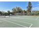 Outdoor tennis court with a net and chain link fence at 3468 51St Avenue W Dr, Bradenton, FL 34210