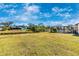 Expansive backyard with a screened-in pool and water views under clear blue skies at 3988 Abbotsford St, North Port, FL 34287