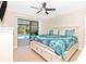 Large bedroom with a ceiling fan, sliding glass doors leading to the pool area, and plenty of natural light at 3988 Abbotsford St, North Port, FL 34287