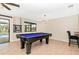 Game room with pool table and view of the backyard pool at 3988 Abbotsford St, North Port, FL 34287