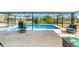 Relaxing screened pool area with patio furniture at 3988 Abbotsford St, North Port, FL 34287