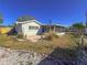 Backyard featuring a brick patio, an enclosed sunroom and mature trees at 4001 17Th W Ave, Bradenton, FL 34205
