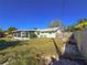 Well-maintained backyard with a screen lanai, green grass, rock accents, and privacy fence at 4001 17Th W Ave, Bradenton, FL 34205