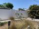 Landscaped backyard featuring a white vinyl fence, pink flowering plant and decorative tiki torches at 4001 17Th W Ave, Bradenton, FL 34205