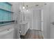 Modern bathroom with a double vanity, wood look floors, updated lighting and a large closet at 4001 17Th W Ave, Bradenton, FL 34205