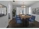 Elegant dining room with modern chandelier, wood table, and views of the kitchen at 4001 17Th W Ave, Bradenton, FL 34205