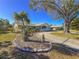 Home featuring a well-kept lawn, circular driveway, mature trees, and inviting curb appeal at 4001 17Th W Ave, Bradenton, FL 34205