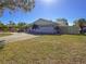 Charming home featuring a two-car garage, well-maintained lawn, and tropical landscaping at 4001 17Th W Ave, Bradenton, FL 34205