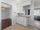 Charming kitchenette featuring granite counters, white cabinets, and tiled floors at 4001 17Th W Ave, Bradenton, FL 34205