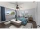 Serene main bedroom with a ceiling fan, ample natural light, and stylish decor at 4001 17Th W Ave, Bradenton, FL 34205