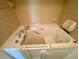 Close-up of the walk-in bathtub with jets and safety features at 4339 Bowling Green Cir # 19, Sarasota, FL 34233
