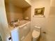 Bathroom with walk-in tub, toilet, and neutral tile at 4339 Bowling Green Cir # 19, Sarasota, FL 34233