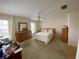 Bedroom with carpeted floors, ceiling fan, and ample natural light at 4339 Bowling Green Cir # 19, Sarasota, FL 34233