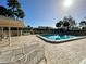 Inviting community pool with a paved deck, lounge chairs, and a covered seating area at 4339 Bowling Green Cir # 19, Sarasota, FL 34233
