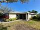 Side exterior view of a single-story home with screened porch and landscaped yard at 4339 Bowling Green Cir # 19, Sarasota, FL 34233