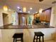 Kitchen with breakfast bar, granite countertops, stainless steel appliances, and wood cabinetry at 4339 Bowling Green Cir # 19, Sarasota, FL 34233