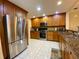 Kitchen featuring stainless steel appliances, wood cabinetry, granite countertops, and recessed lighting at 4339 Bowling Green Cir # 19, Sarasota, FL 34233