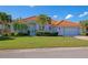 Single-story home with tile roof, palm trees, and landscaped lawn at 4432 Golden Lake Dr, Sarasota, FL 34233