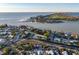 Aerial perspective of a coastal property nestled within a residential neighborhood, with a beach in the background at 451 Bowdoin Cir, Sarasota, FL 34236