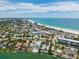 Aerial view showcasing waterfront homes and a beautiful beach along a picturesque coastline at 451 Bowdoin Cir, Sarasota, FL 34236