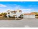 Large, white two-story home with a three-car garage and damaged tile roof at 451 Bowdoin Cir, Sarasota, FL 34236