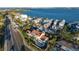 Aerial perspective of a waterfront property with a pool, surrounded by other homes under construction at 451 Bowdoin Cir, Sarasota, FL 34236