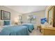 Two twin beds in a bedroom with light teal bedding and light wood floors at 4515 45Th W Ave # 202A, Bradenton, FL 34210