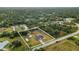 Aerial view of a property with a large backyard, pool, and a shed, surrounded by trees at 5105 Bannock Cir, North Port, FL 34288