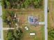 Top-down aerial view showcasing the house, pool, yard, and surrounding trees at 5105 Bannock Cir, North Port, FL 34288