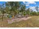Spacious backyard with a patio area, fire pit, and lush landscaping at 5105 Bannock Cir, North Port, FL 34288