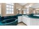 Modern bathroom with green marble countertops, white cabinets, and a soaking tub at 5105 Bannock Cir, North Port, FL 34288