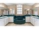 Elegant bathroom with dual vanities, a large soaking tub, and green marble countertops at 5105 Bannock Cir, North Port, FL 34288