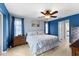 Blue bedroom with a king-size bed, wooden furniture, and ceiling fan at 5105 Bannock Cir, North Port, FL 34288