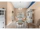 Dining area with chandelier, wooden table, and white hutch at 5105 Bannock Cir, North Port, FL 34288