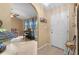 Welcoming foyer with arched entryway, piano, and access to the living area at 5105 Bannock Cir, North Port, FL 34288