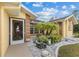 Front entryway with a screened door and decorative landscaping at 5105 Bannock Cir, North Port, FL 34288