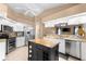 Bright kitchen featuring white cabinets, stainless steel appliances, and granite counters at 5105 Bannock Cir, North Port, FL 34288