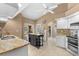 Kitchen with granite counters, white cabinetry, island, and stainless steel appliances at 5105 Bannock Cir, North Port, FL 34288