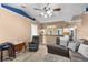 Cozy Gathering room with sectional sofa, open view to the adjacent kitchen, and ample natural light at 5105 Bannock Cir, North Port, FL 34288
