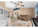 Combined living and dining area with white hutch, loveseat, and piano at 5105 Bannock Cir, North Port, FL 34288