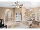 Living room featuring a loveseat, piano, arched entryways, and dining area at 5105 Bannock Cir, North Port, FL 34288