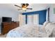 Serene main bedroom with king-size bed, private patio access, and blue accent wall at 5105 Bannock Cir, North Port, FL 34288