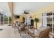 Outdoor pool area featuring a hot tub, dining set, wicker furniture, and a ceiling fan at 5105 Bannock Cir, North Port, FL 34288